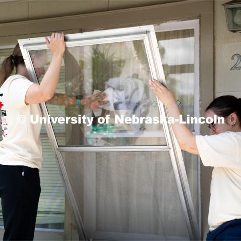 Members of Tri Delta clean the exterior windows of a homeowner’s house during the Big Event. May 4, 2024. Photo by Kirk Rangel for University Communication.